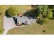 Birds eye view of the roof with decks and gravel driveway with grass and trees around the house at 413 Bayles Rd, Lillington, NC 27546