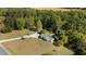 Aerial view of ranch home, long drive, nice landscape and wooded lot at 413 Bayles Rd, Lillington, NC 27546
