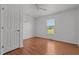 Bright, neutral bedroom with natural light and wood laminate flooring at 413 Bayles Rd, Lillington, NC 27546