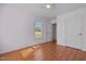 This bedroom has pink walls, wood floors, and a window for natural light at 413 Bayles Rd, Lillington, NC 27546