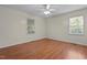 Bedroom featuring two windows, neutral walls, and laminate wood flooring at 413 Bayles Rd, Lillington, NC 27546