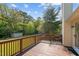 Beautiful wooden deck overlooking a spacious backyard with lush green lawn and mature trees in the distance at 413 Bayles Rd, Lillington, NC 27546