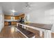 Spacious dining area featuring a long table with bench seating, complemented by ample natural light and kitchen views at 413 Bayles Rd, Lillington, NC 27546