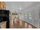 Bright dining area featuring a wooden table with bench seating, enhanced by natural light and seamless access to the kitchen at 413 Bayles Rd, Lillington, NC 27546