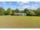 Exterior view of home with inviting porch, spacious front lawn, and private surroundings at 413 Bayles Rd, Lillington, NC 27546