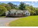 Ranch style home with nice deck, landscaping and black shutters at 413 Bayles Rd, Lillington, NC 27546