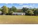 Ranch style home with nice deck, landscaping and black shutters at 413 Bayles Rd, Lillington, NC 27546