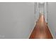 Hallway with grey walls and wooden floor, leading to other rooms at 413 Bayles Rd, Lillington, NC 27546