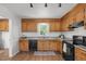 Traditional kitchen featuring wood cabinets, granite counters, and modern appliances, providing a blend of style and functionality at 413 Bayles Rd, Lillington, NC 27546