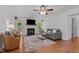 Bright living room features a fireplace, ceiling fan, wood flooring, and access to the backyard at 413 Bayles Rd, Lillington, NC 27546