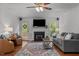 Inviting living room with a cozy fireplace, plush seating, and natural light, perfect for relaxation and entertainment at 413 Bayles Rd, Lillington, NC 27546