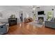 Cozy living room with a fireplace, ceiling fan, and wood laminate flooring at 413 Bayles Rd, Lillington, NC 27546