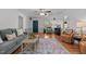 Inviting living room with wood laminate flooring and a modern area rug at 413 Bayles Rd, Lillington, NC 27546