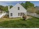 A view of the back exterior with a white fence, well-manicured lawn and patio area at 4414 Nightfall Ct, Durham, NC 27713