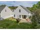 A view of the back exterior featuring a white fence, grass, patio and landscaping at 4414 Nightfall Ct, Durham, NC 27713