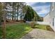 Backyard with patio, string lights, and a row of trees at 4414 Nightfall Ct, Durham, NC 27713