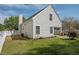A view of the backyard with a white-picket fence, green grass and exterior of the house at 4414 Nightfall Ct, Durham, NC 27713