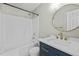 Updated bathroom with a navy vanity, gold fixtures, and a shower-tub combination at 4414 Nightfall Ct, Durham, NC 27713