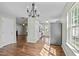 Open-concept dining area featuring hardwood floors and a modern chandelier at 4414 Nightfall Ct, Durham, NC 27713
