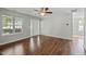 Bright living room with hardwood floors, a ceiling fan, and large windows at 4414 Nightfall Ct, Durham, NC 27713