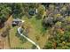 Large lot with a winding driveway leads to this home with lush trees and landscaping at 460 Mann Rd, Coats, NC 27521