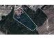 Aerial view of property lines highlighting the large lot with lush trees surrounding the home at 460 Mann Rd, Coats, NC 27521