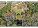 This aerial shot highlights the large lot, pond and wooded setting of this property at 460 Mann Rd, Coats, NC 27521