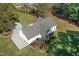 An aerial view of the home displays a well-manicured yard, back deck, and screened porch at 460 Mann Rd, Coats, NC 27521