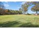 A large backyard featuring mature trees and a long view of the wooded area and the house at 460 Mann Rd, Coats, NC 27521