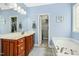 Bathroom with double sinks, wood cabinets and a soaking tub at 460 Mann Rd, Coats, NC 27521