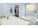 Relaxing light blue bathroom with soaking tub and walk in closet at 460 Mann Rd, Coats, NC 27521