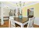 Dining room showcasing a rustic wood table, white chairs, and an ornate chandelier at 460 Mann Rd, Coats, NC 27521