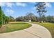 A long driveway leading up to the house, with manicured landscaping and mature trees at 460 Mann Rd, Coats, NC 27521