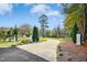 A long driveway leading up to the house, with manicured landscaping and mature trees at 460 Mann Rd, Coats, NC 27521