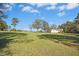 A wide front yard featuring mature trees and a long driveway leading up to the house at 460 Mann Rd, Coats, NC 27521