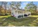 A detached garage with two bays, a covered patio area, landscaping, and a covered storage area at 460 Mann Rd, Coats, NC 27521
