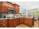 Kitchen featuring wood cabinets, modern appliances, and open breakfast area at 460 Mann Rd, Coats, NC 27521
