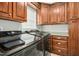 Laundry room with black washer and dryer and custom wooden cabinets at 460 Mann Rd, Coats, NC 27521