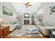 Comfortable living room with a fireplace, two sofas, a ceiling fan and hardwood floors at 460 Mann Rd, Coats, NC 27521