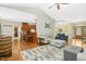 Open-concept living room with hardwood floors, a fireplace, and access to other living areas at 460 Mann Rd, Coats, NC 27521