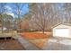 The backyard has a detached garage, driveway and wooden deck at 4720 Brigadoon Dr, Durham, NC 27705