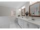 Bright bathroom features dual sinks, white countertops, and modern fixtures at 4720 Brigadoon Dr, Durham, NC 27705