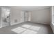 Large bedroom with neutral walls and carpet with ensuite bath and two closets at 4720 Brigadoon Dr, Durham, NC 27705