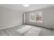 Cozy bedroom with gray walls and carpet features two large windows that provide ample natural light at 4720 Brigadoon Dr, Durham, NC 27705