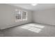 This is a bright bedroom with neutral walls and carpet with natural light at 4720 Brigadoon Dr, Durham, NC 27705