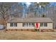 Charming single-story home features a red front door and a well-maintained front yard at 4720 Brigadoon Dr, Durham, NC 27705