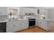 Modern kitchen featuring white cabinets, stainless steel appliances, and a stylish backsplash at 4720 Brigadoon Dr, Durham, NC 27705