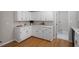 Well-lit kitchen with white cabinetry, quartz countertops and stainless steel dishwasher at 4720 Brigadoon Dr, Durham, NC 27705