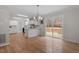 Open-concept living room featuring hardwood floors and sliding glass doors leading to the backyard at 4720 Brigadoon Dr, Durham, NC 27705