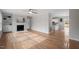 Inviting living room with hardwood floors, a fireplace, and an open view to the kitchen area at 4720 Brigadoon Dr, Durham, NC 27705